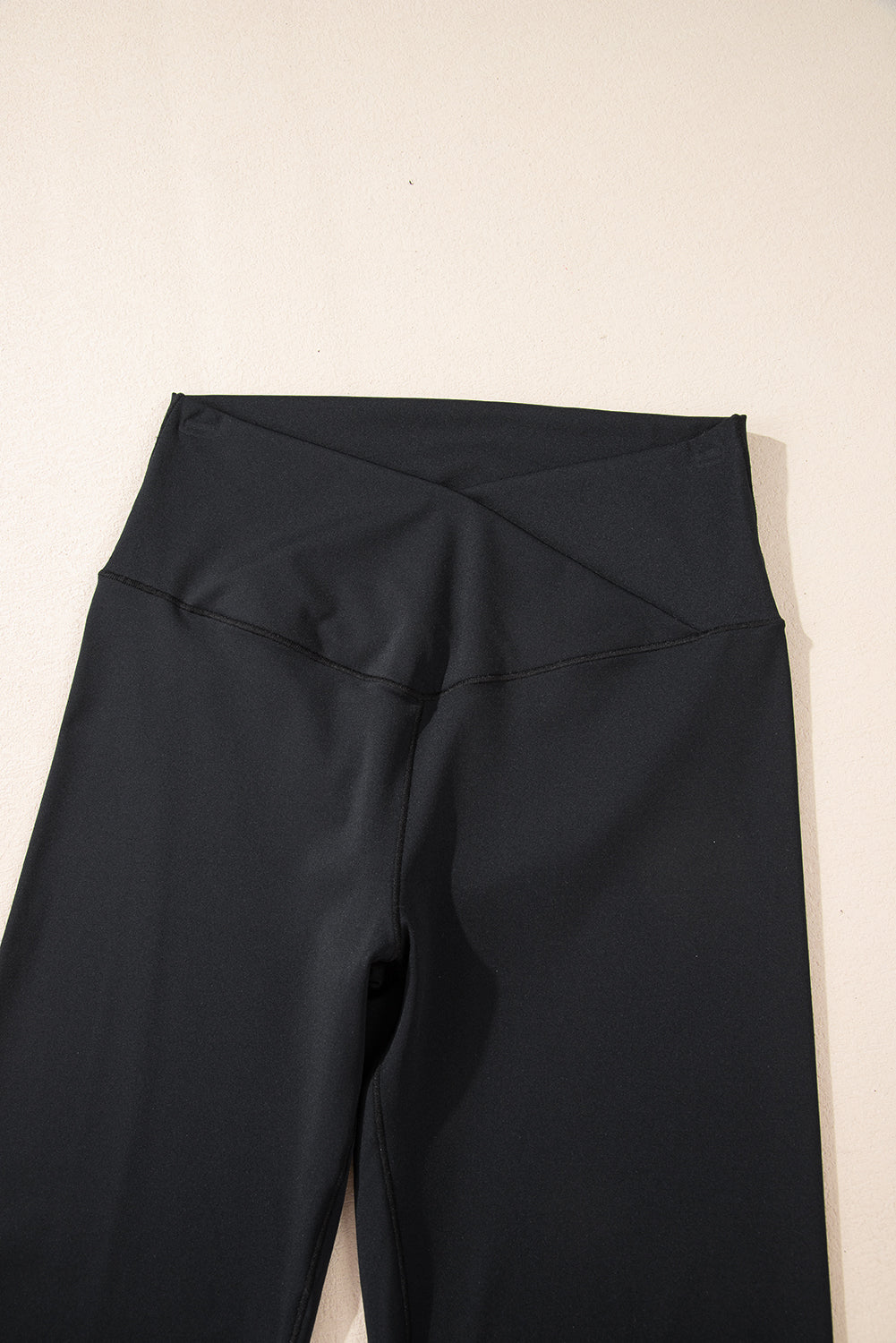 Black high waist, v-shape, flare leg leggings, close up of front waist