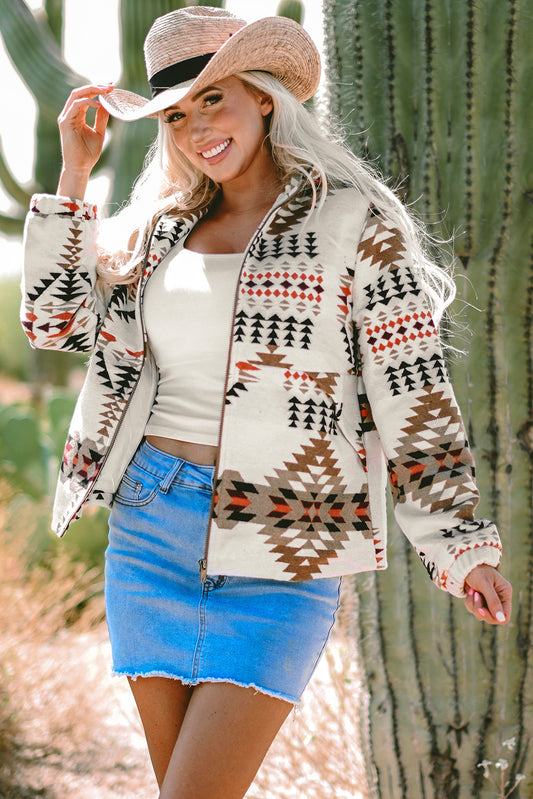 Cowgirl wearing featured Aztec Printed Zip Up Jacket in Beige, paired with a denim mini skirt, and tan cowboy hat